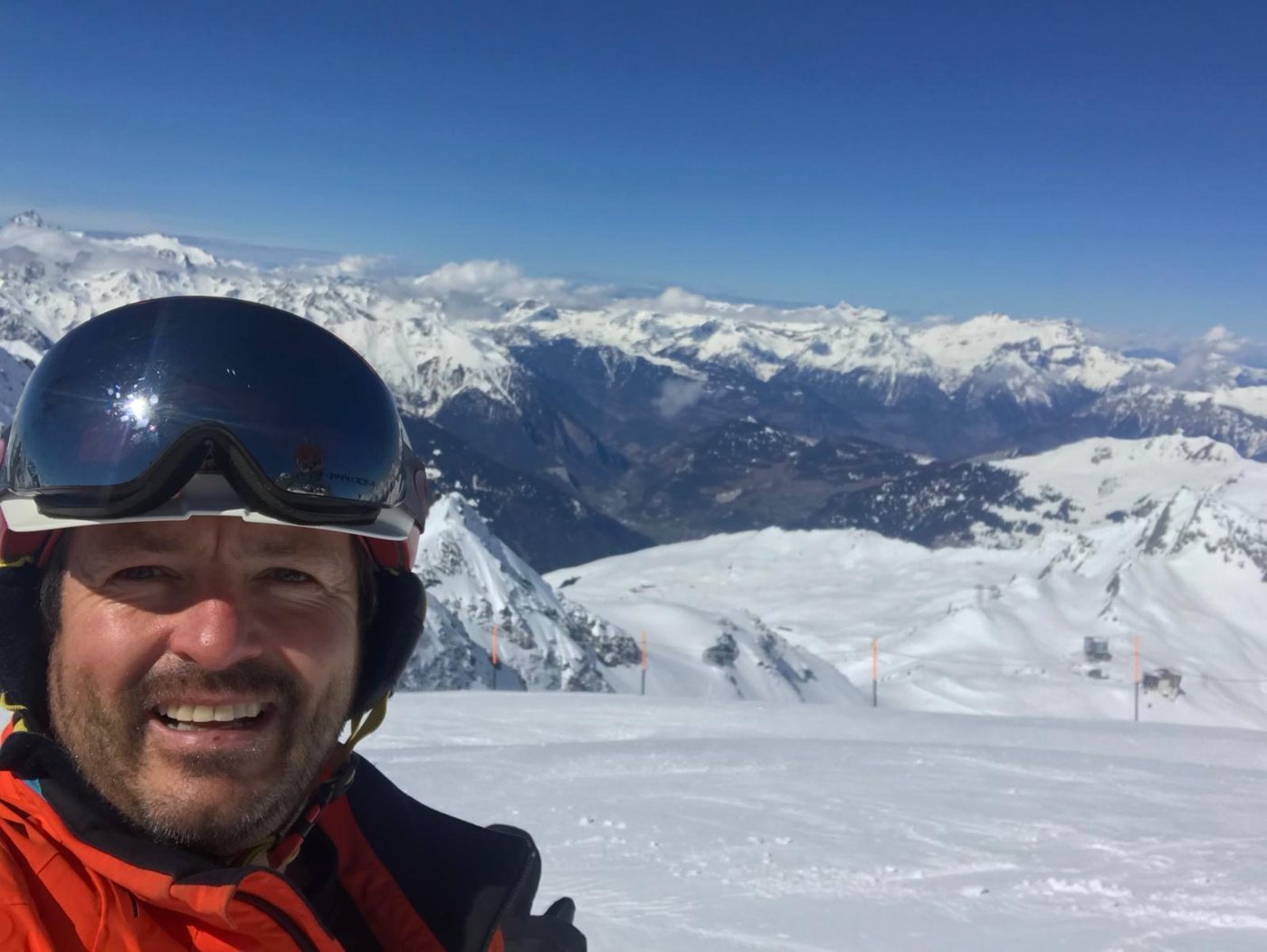 Darren Parker on the slopes, with snow-covered Alpine peaks behind him
